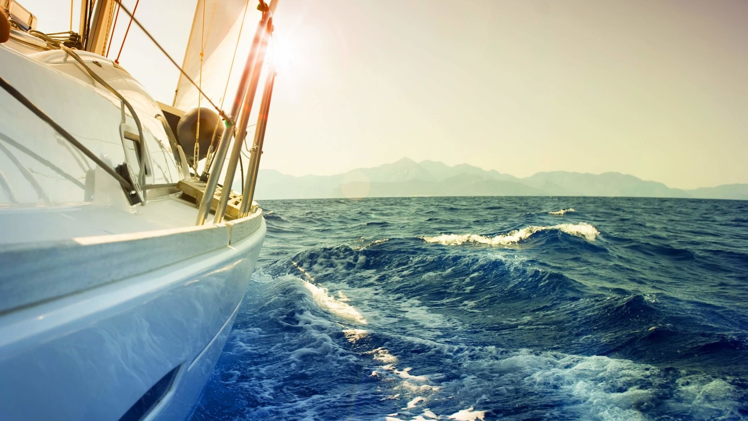 Yacht Sailing Downwind at Sunset Wallpaper for Desktop 2560x1440